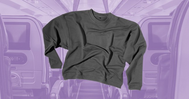 A jumper on a purple-hued plane background.
