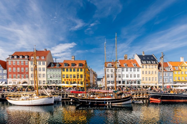Colourful houses and boats on the water along the waterfront in Copenhagen